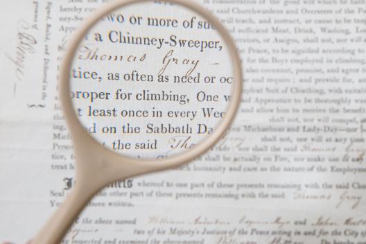 Magnifying glass over historic text