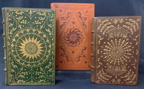 Amateur binder Alvah Cook tried several versions of some binding styles, these ones are based on a 17th century Scottish wheel design. By changing tools around, different effects could be obtained within the same style.